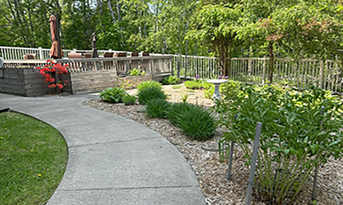 Beautiful outdoor walkway and patio at the Mount Royal Pines III Assisted Living facility